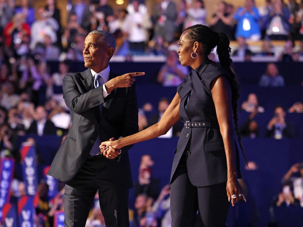 Former First Lady Michelle Obama (R) introduces former President Barack Obama on the second day of the Democratic National Convention at the United Center in Chicago, Illinois, on August 20, 2024. 