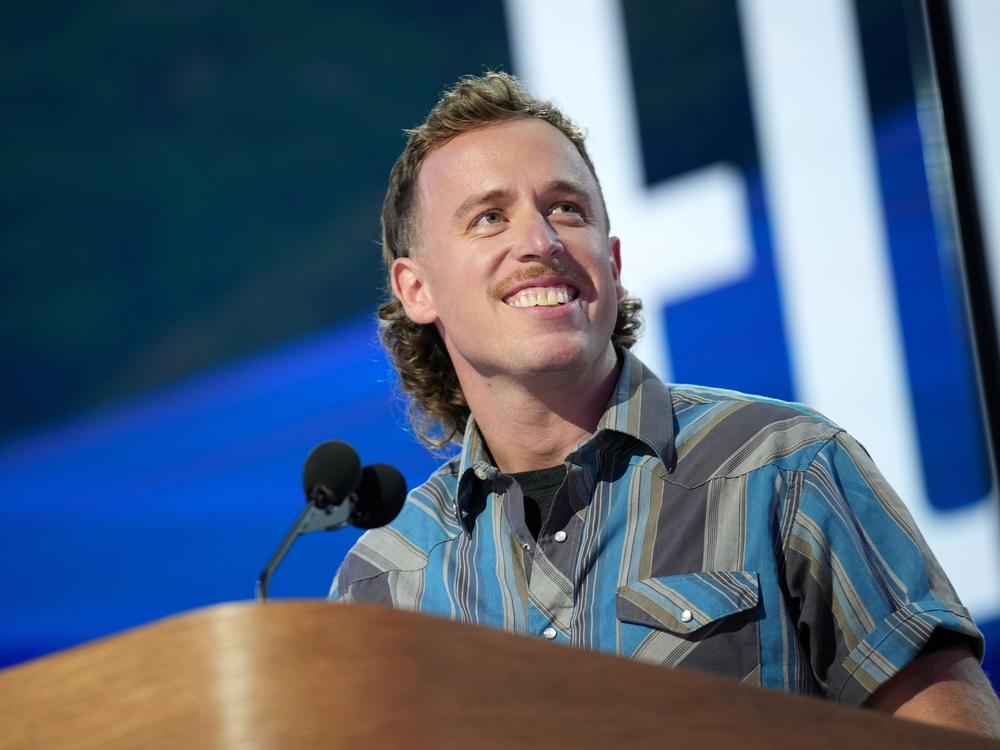 Content creator John Russell speaks on stage during the final day of the DNC in Chicago. 