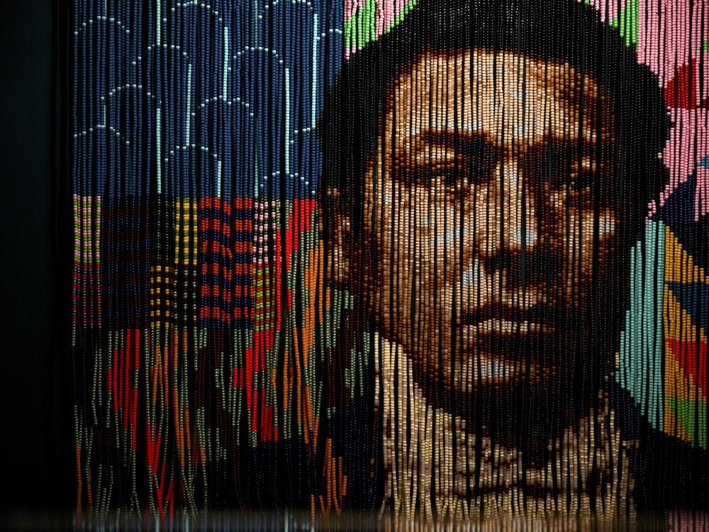 “Wail on Whalers, a Portrait of Amos Haskins” by Felandus Thames, an “homage to escaped enslaved people who found autonomy in whaling,” is comprised of hairbeads strung on coated wire. The piece is part of the “Entwined” exhibition, which reimagines thousands of years of maritime history through Black and Indigenous worldviews and experiences. (Ryan Caron King/Connecticut Public)