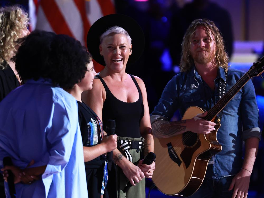 Musician Pink, her daughter Willow Sage Hart (2nd L) and guitarist Justin Derrico (R) take part in stage testing ahead of the start of the final day of the Democratic National Convention.