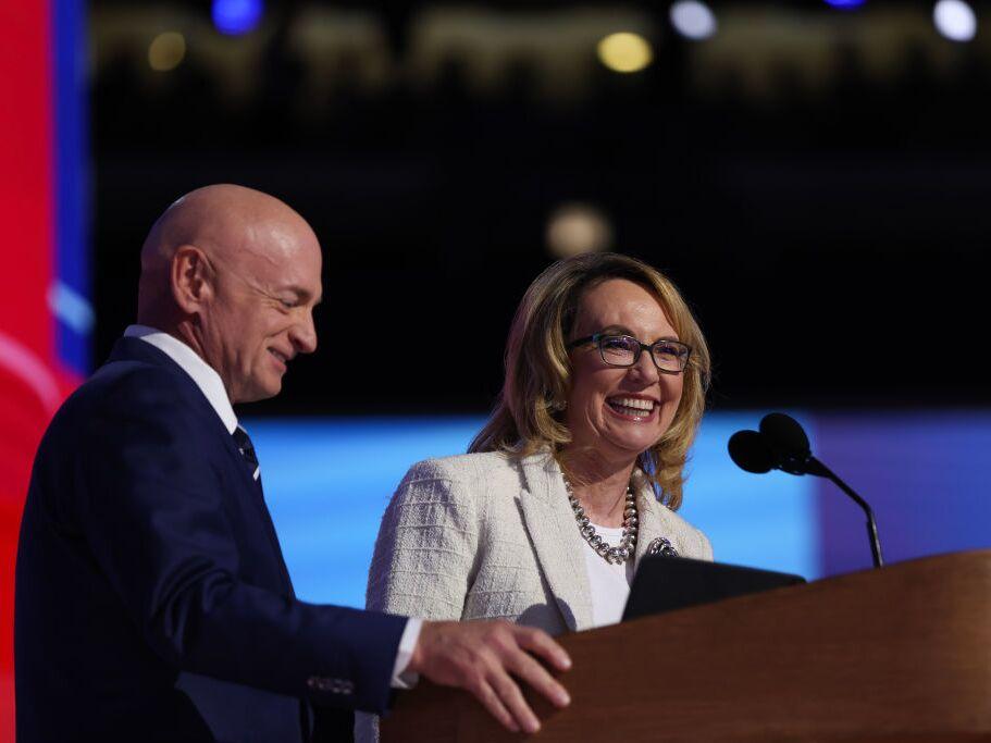 Gun control advocate and former U.S. Rep. Gabby Giffords, D-Arizona, speaks on stage with her husband, U.S. Sen. Mark Kelly, D-Arizona, during the final day of the Democratic National Convention at the United Center on Thursday in Chicago, Illinois. Delegates, politicians, and Democratic Party supporters are gathering in Chicago, as current Vice President Kamala Harris is named her party's presidential nominee. 