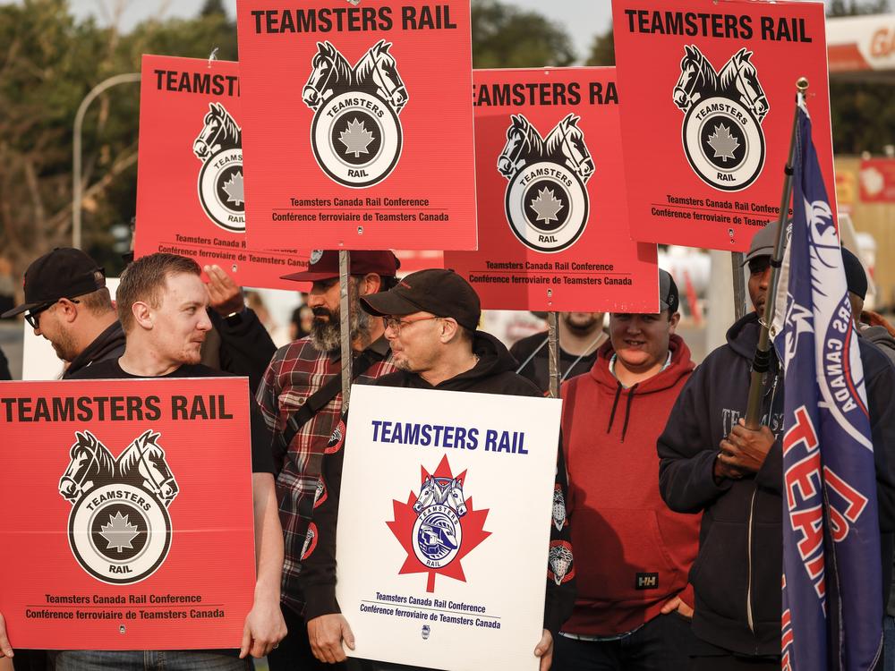 Teamsters Canada Rail Conference members picket outside the CPKC headquarters in Calgary, Alta., on Friday.