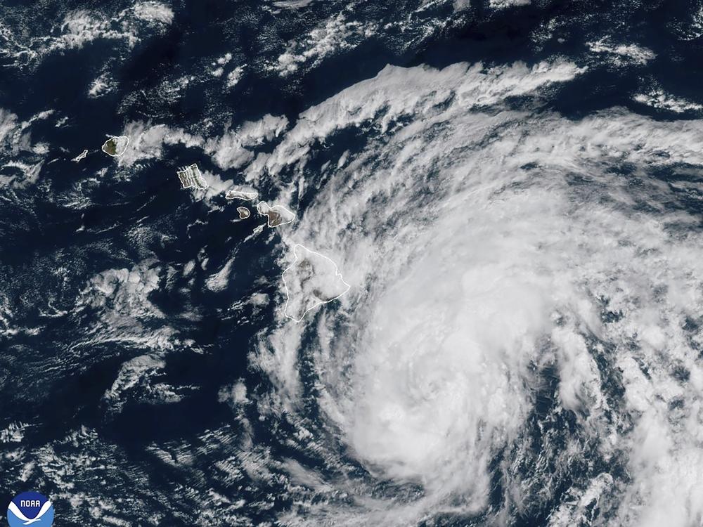 This image provided by the National Oceanic and Atmospheric Administration shows Tropical Storm Hone as it continues to track to the west toward the Hawaiian Islands on Saturday.