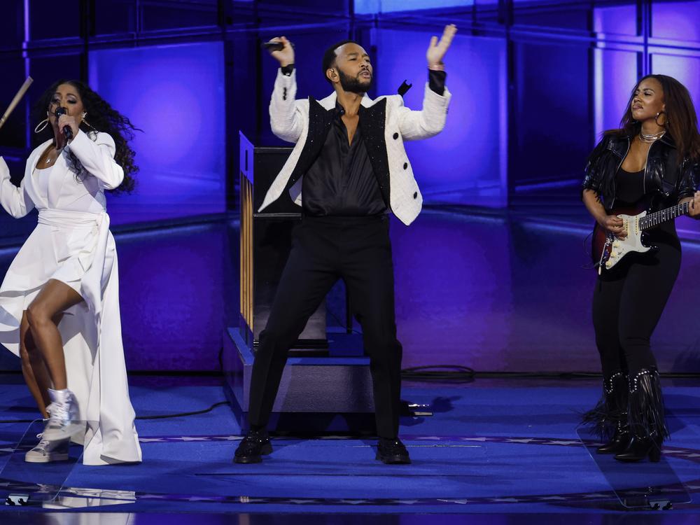 Musicians John Legend, Ari O'Neal and Sheila E. perform on stage during the third day of the Democratic National Convention in Chicago, Illinois.