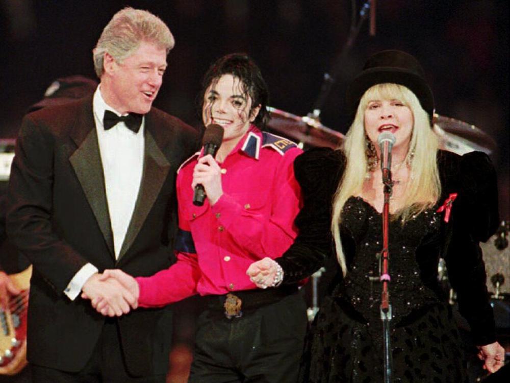 Then-President Clinton shakes hands with Michael Jackson as Stevie Nicks sings during inauguration festivities in Landover, Md.