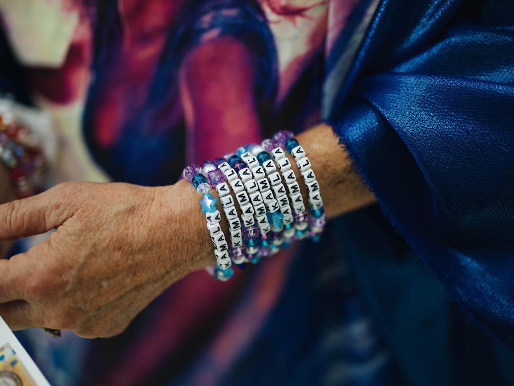 Kelly Jacobs wears bracelets that read 