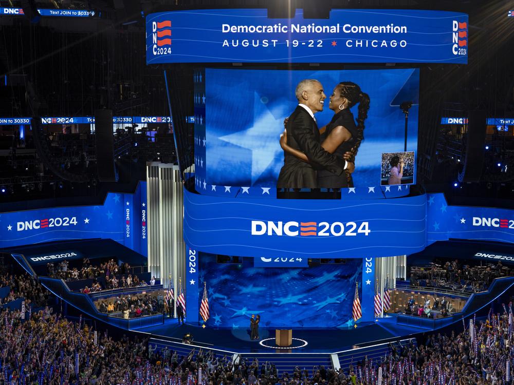 Former President Barack Obama and Former US First Lady Michelle Obama embrace on the second night of the DNC.