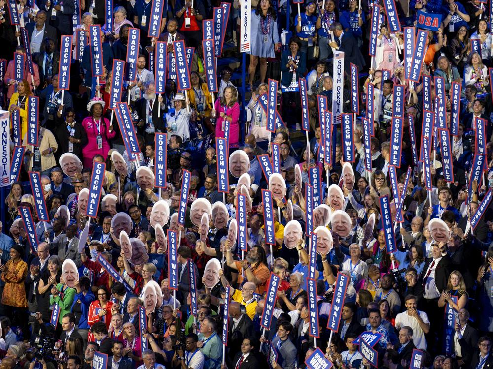 Delegates hold up signs reading 