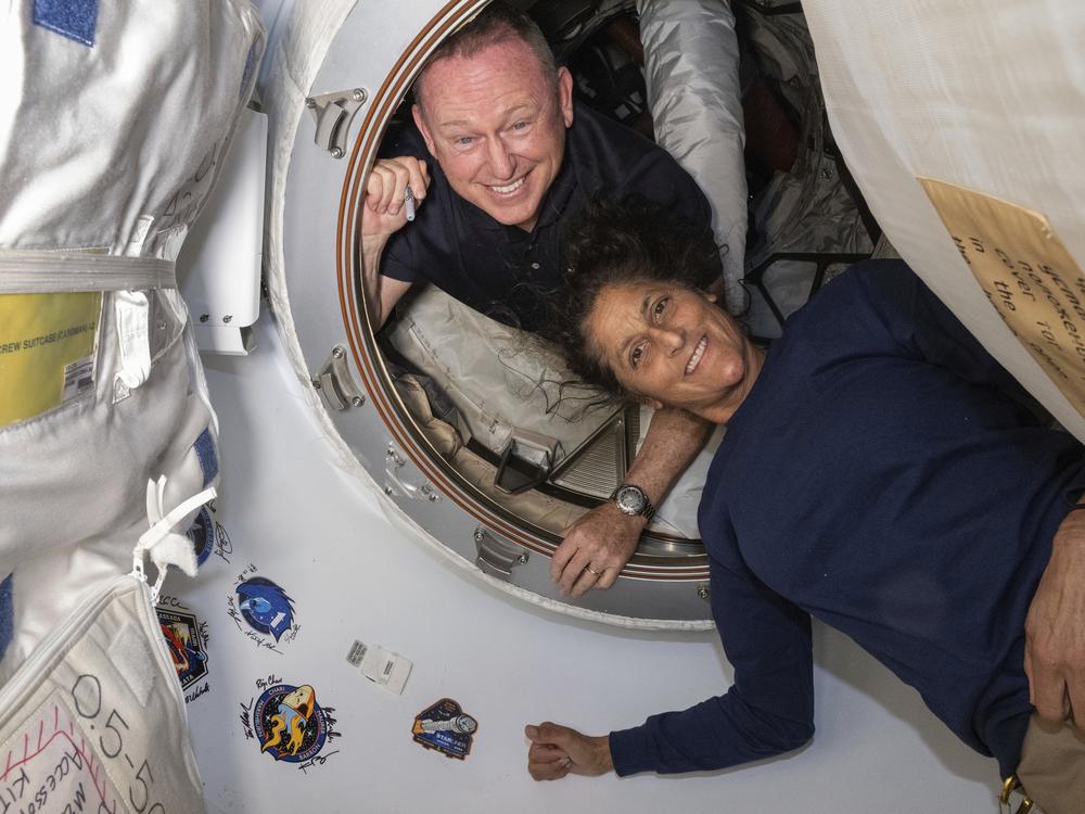 In this photo provided by NASA, Boeing Crew Flight Test astronauts Butch Wilmore (left) and Suni Williams pose for a portrait inside the vestibule between the forward port on the International Space Station's Harmony module and Boeing's Starliner spacecraft on June 13.  
