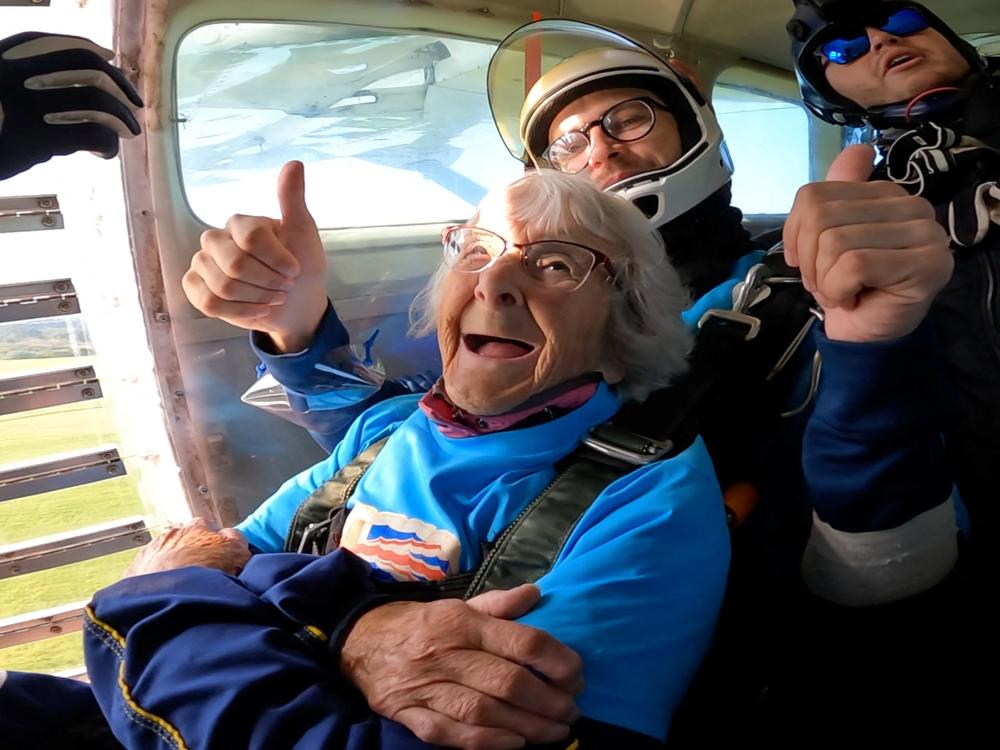 In this screengrab taken from a handout video, Manette Baillie, 102, smiles as she prepares to skydive over England on Sunday.