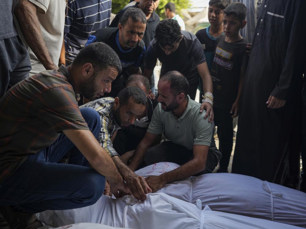 Palestinians mourn relatives killed in the Israeli bombardment of the Gaza Strip, at a hospital in Deir al-Balah, Tuesday.