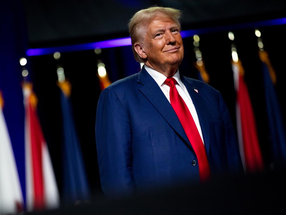Republican presidential nominee and former President Donald Trump smiles at a crowd in Detroit on Monday.