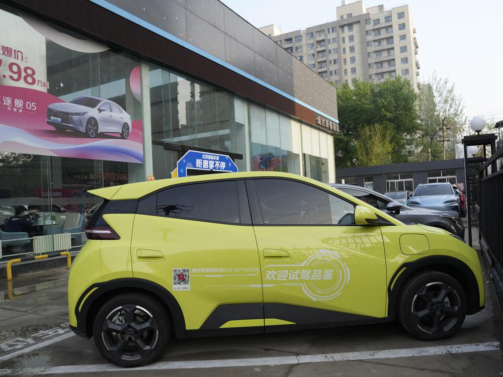 A Seagull electric vehicle from Chinese automaker BYD for test driving is parked outside a showroom in Beijing on April 10. The tiny, low-priced electric vehicle called the Seagull has American automakers and politicians trembling. The car, launched last year by Chinese automaker BYD, sells for around $12,000 in China. But it drives well and is put together with craftsmanship that rivals U.S.-made electric vehicles that cost three times as much. Tariffs on imported Chinese vehicles probably will keep the S…
