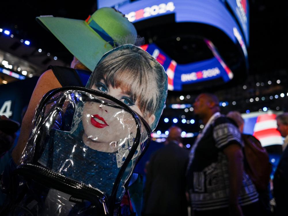 An attendee wears a backpack with a Taylor Swift sign during the third day of the Democratic National Convention in Chicago. Swifties for Kamala, a grassroots group not affiliated either with Swift or the Harris campaign, raised more than $140,000 for the Democratic presidential nominee after a call Tuesday night.