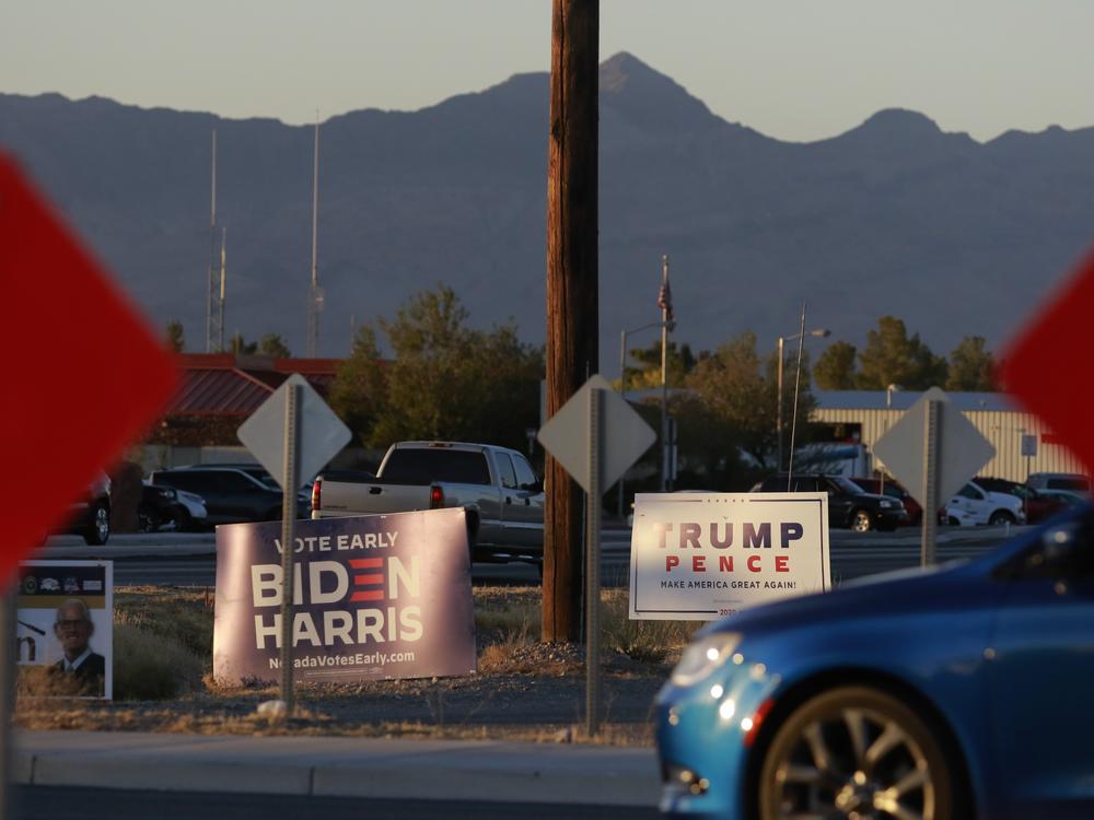 Campaign signs at an intersection near a voting station in November 2020, in Pahrump, Nev.