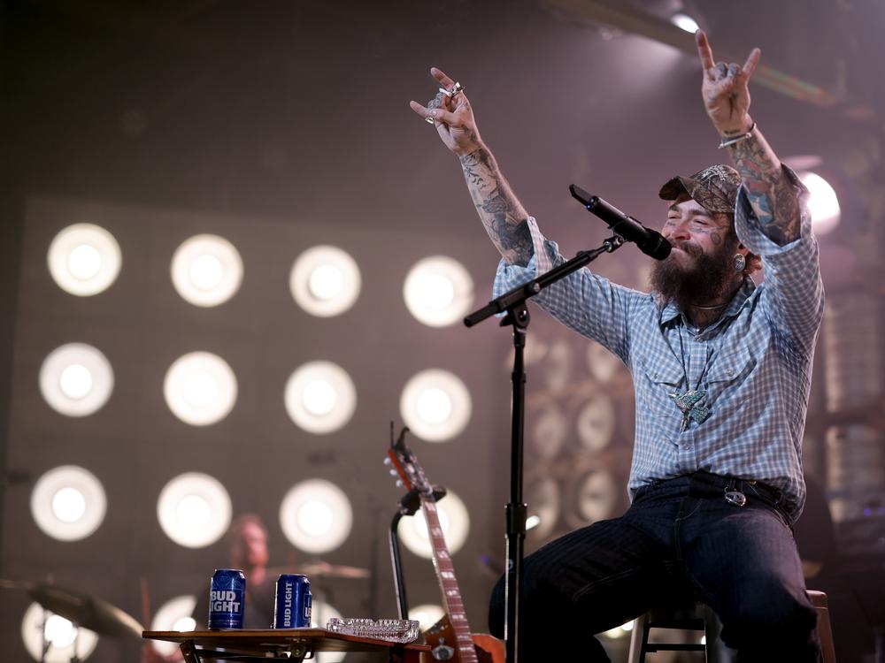 Post Malone, who has spent the year shifting his focus from hip-hop and pop toward country music (scoring a No. 1 single in the process) performs on July 16, 2024, in Nashville, Tenn. His first all-country album, <em>F-1 Trillion</em>, topped this week's <em>Billboard</em> album chart.