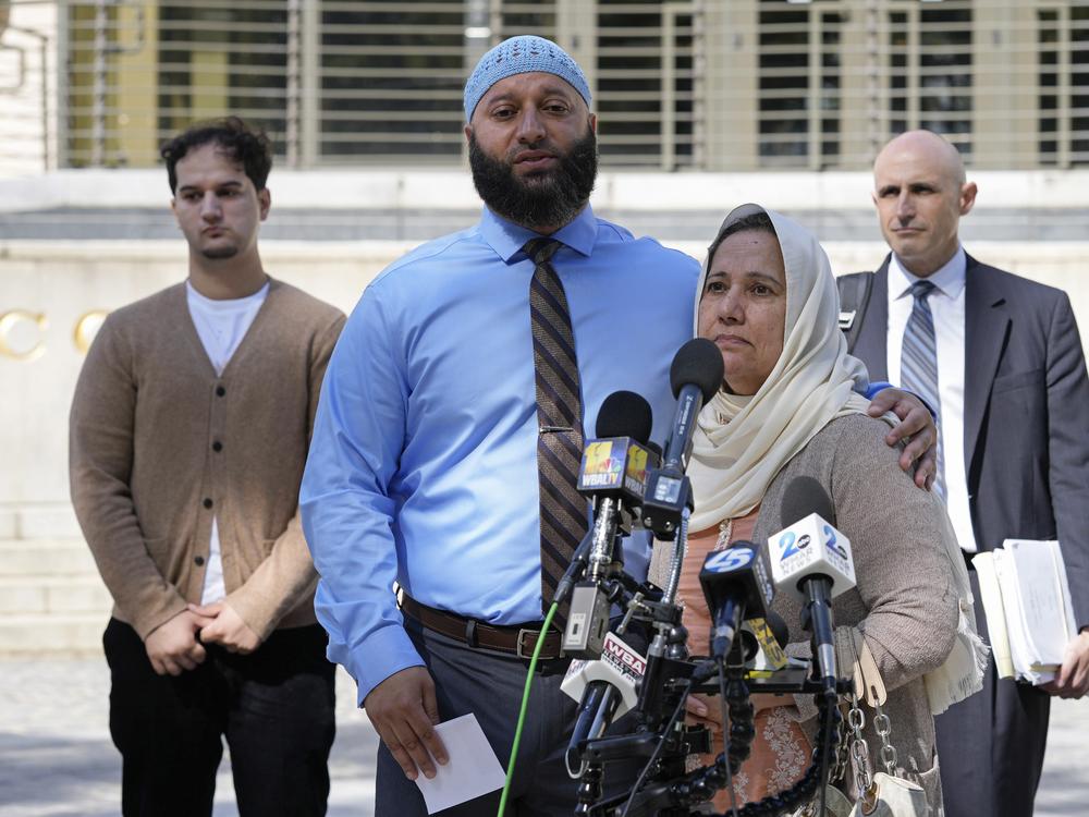 Adnan Syed, standing with his mother Shamim Rahman, talks with reporters outside Maryland's Supreme Court in Annapolis, Md., on Oct. 5, 2023.
