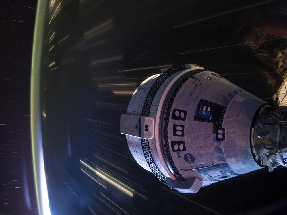 In this long-exposure photo provided by NASA, Boeing's Starliner spacecraft is docked to the Harmony module of the International Space Station on July 3.