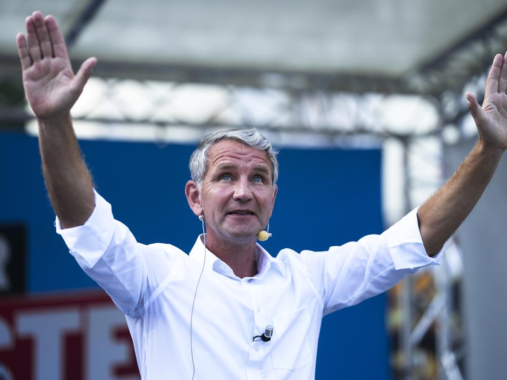 Bjoern Hoecke top candidate in Thuringia of the far-right Alternative for Germany, AfD, party waves to supporters during an election campaign rally in Suhl, Germany, Aug. 13.