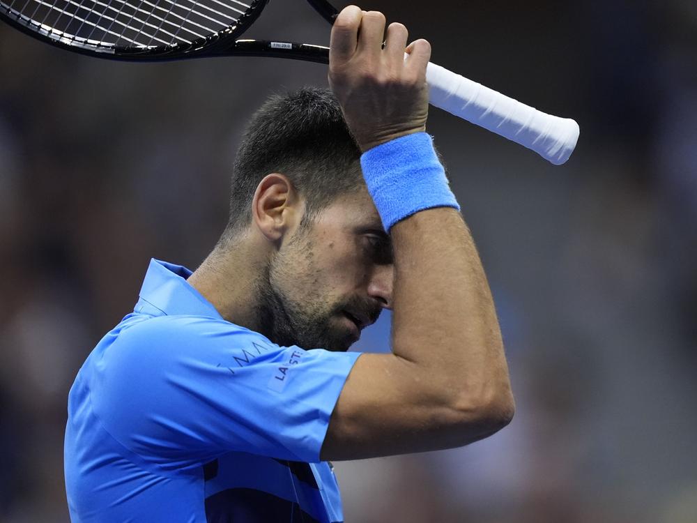 Novak Djokovic of Serbia wipes his face against Alexei Popyrin of Australia during a third round match of the U.S. Open tennis championships on Friday.