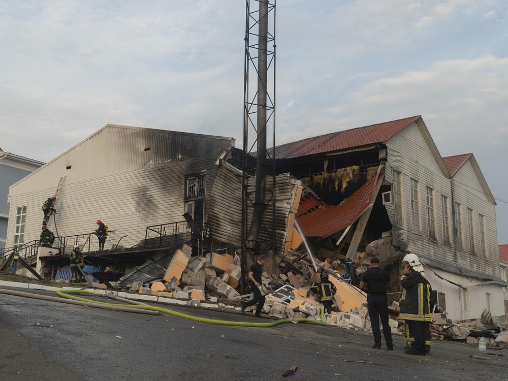 Firefighters extinguish a fire after a rocket hit a building of a higher education institution in the Ukrainian capital Kyiv, on Monday.