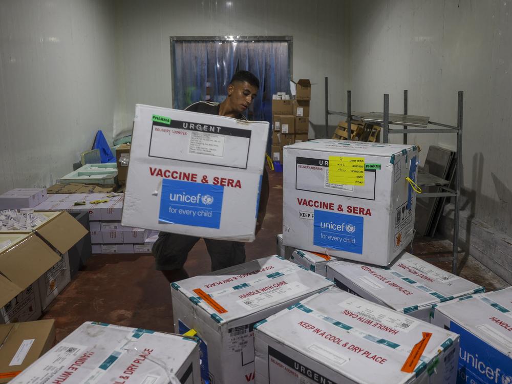 A worker unloads a shipment of polio vaccines provided with support from UNICEF to the Gaza Strip through the Karm Abu Salem crossing, also known as Kerem Shalom, at a depot belonging to Gaza's health ministry on Aug. 25.