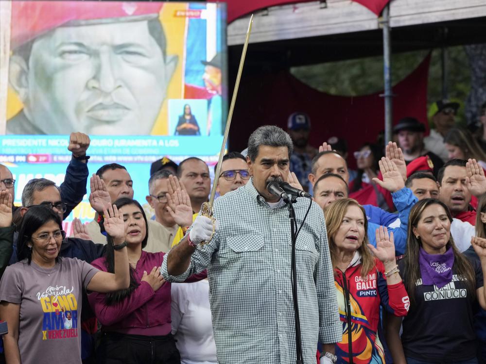 Venezuelan President Nicolás Maduro brandishes a sword as his new Cabinet takes the oath of office, at the presidential palace in Caracas, Venezuela, Aug. 28.