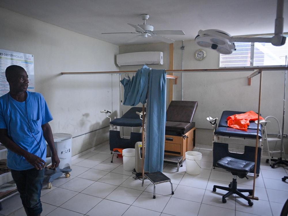 A hospital worker shows the damage inside Fontaine Hospital in Port-au-Prince, Haiti, three days after an armed attack forced its closure last fall.