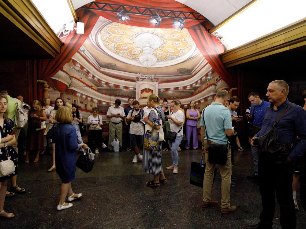 People wait out an air raid alarm at the Teatralna metro station during the massive Russian drone and missile attack in Kyiv, Ukraine, on Aug. 26.