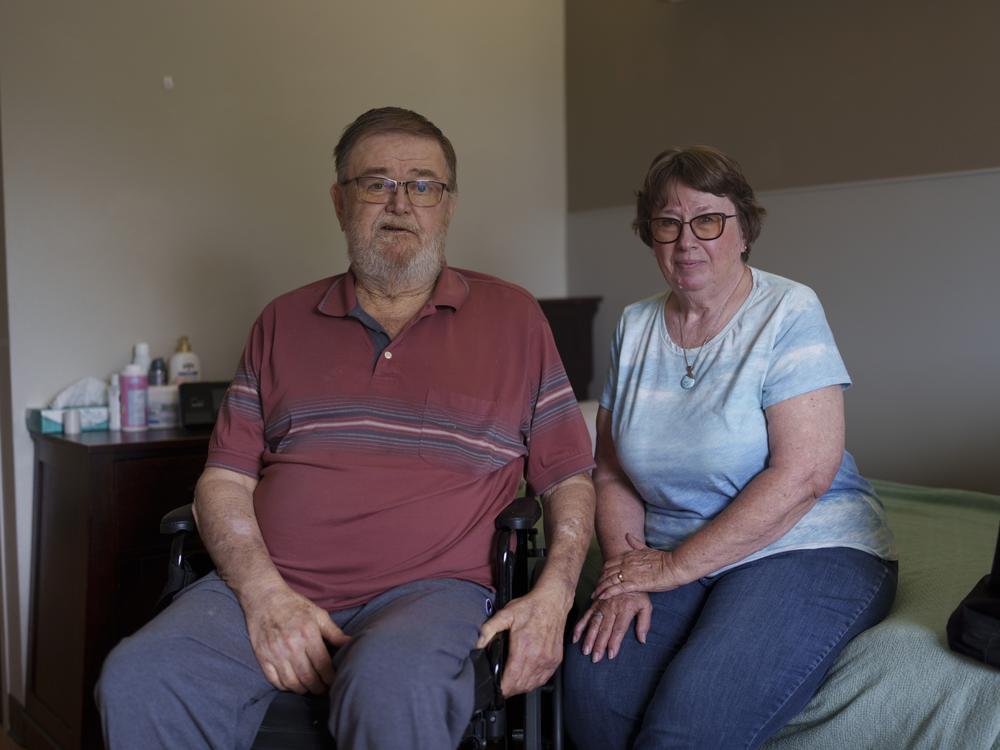 Sherwood and Cindie Haakenson sit in Sherwood’s room at the Heart of America Medical Center long-term care facility in Rugby, N.D.