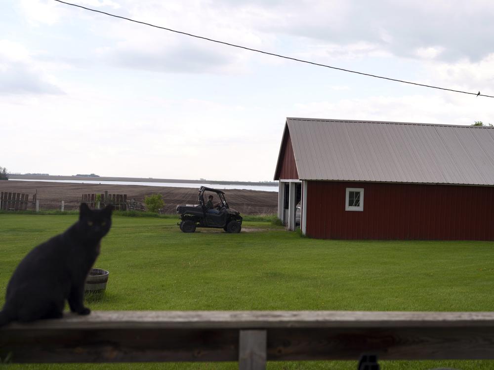 Cindie Haakenson drives an ATV out of her garage in Willow City, N.D., on May 21.