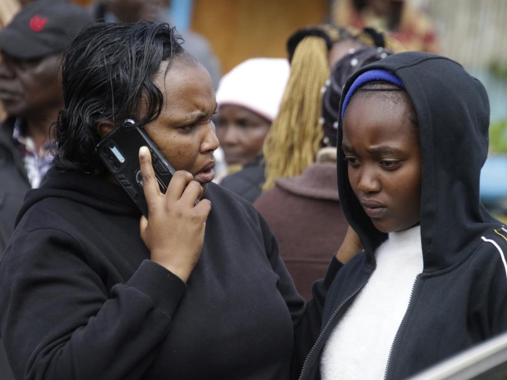 Distressed parents and relatives stand near a burned-out dormitory, following a fire at the Hillside Endarasha Primary in Nyeri, Kenya Friday, Sept. 6, 2024. (AP Photo)