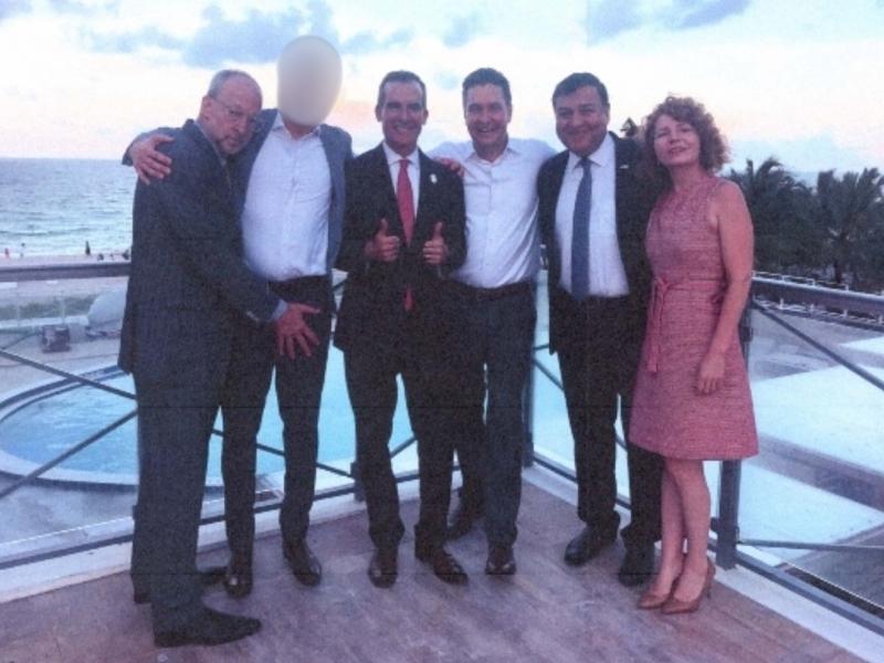 Garcetti (center with his thumbs up) poses for a photo with staffers, advisers and lobbyists on a hotel rooftop in Miami Beach, Florida.