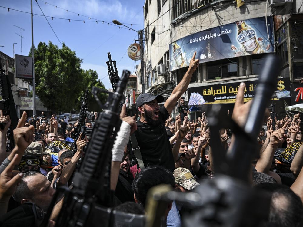 Armed Palestinian militants attend a group funeral of people killed in a raid by Israeli forces, in Jenin, in the occupied West Bank, on May 23.