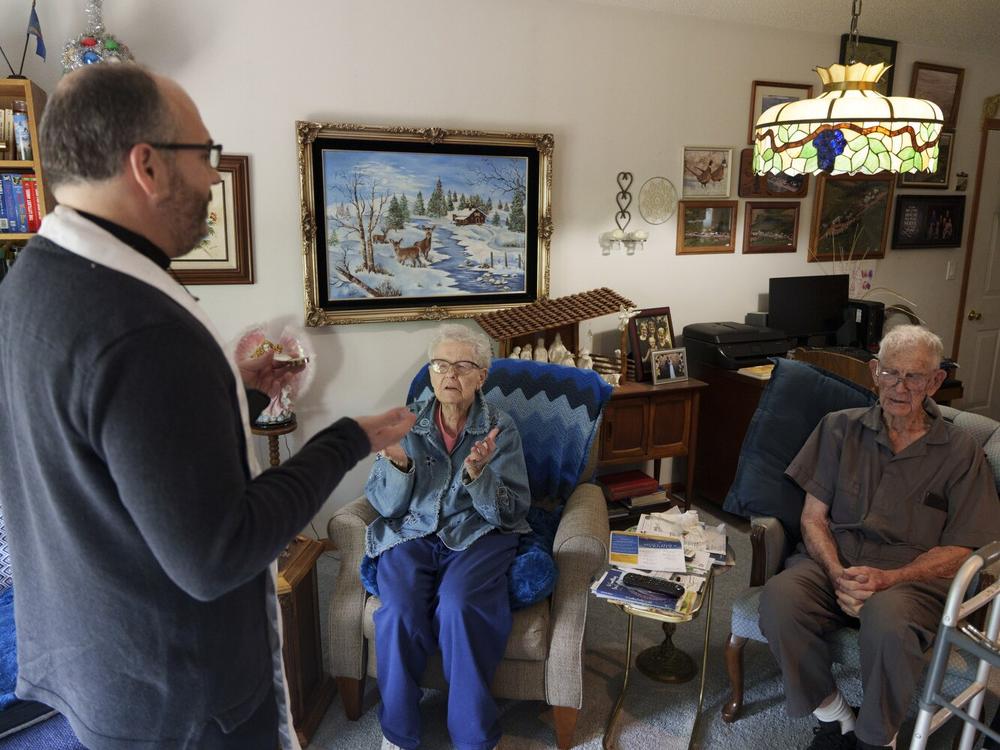 The Rev. Gary Benz offers Holy Communion to Marianne and Jim Schaaf, both in their 90s, at their home in Glen Ullin on May 24. Benz works to support homebound, often socially isolated older adults who are dealing with health concerns by offering them Communion and an opportunity to connect with someone each week.