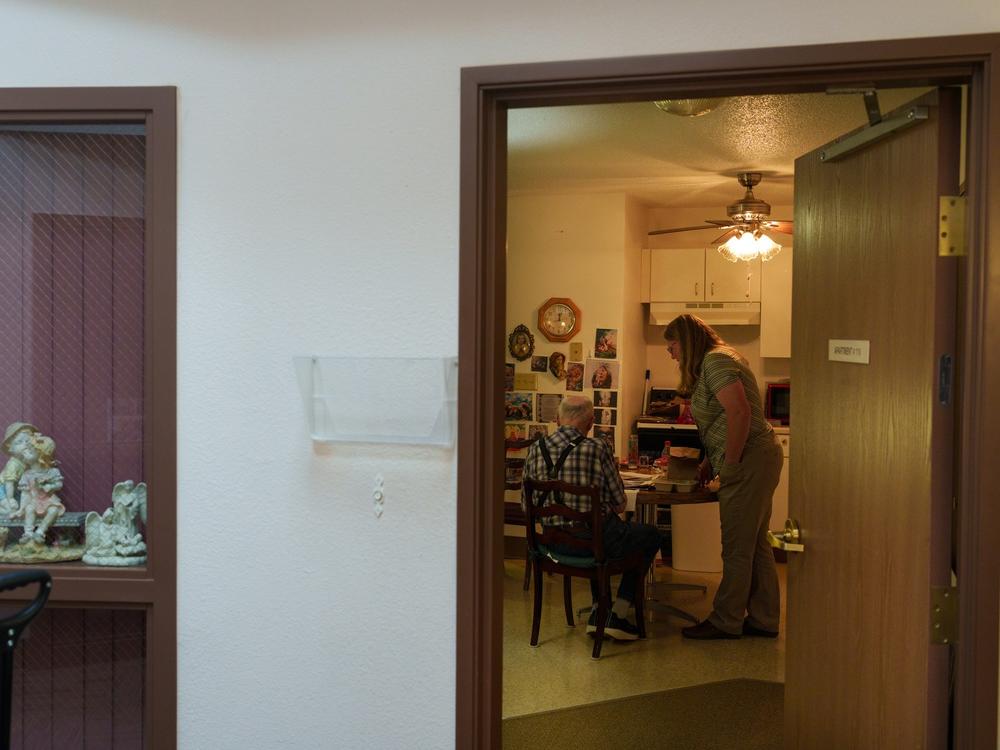 Sanders helps deliver meals to a resident at the Marian Manor senior apartments in Glen Ullin on May 23. 
