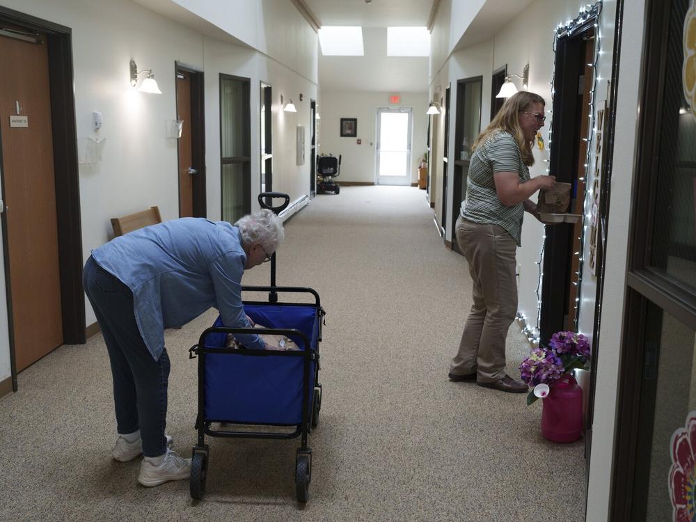 Sanders helps deliver meals to residents at Marian Manor on May 23. She says there are small, affordable ways to help older adults age at home.