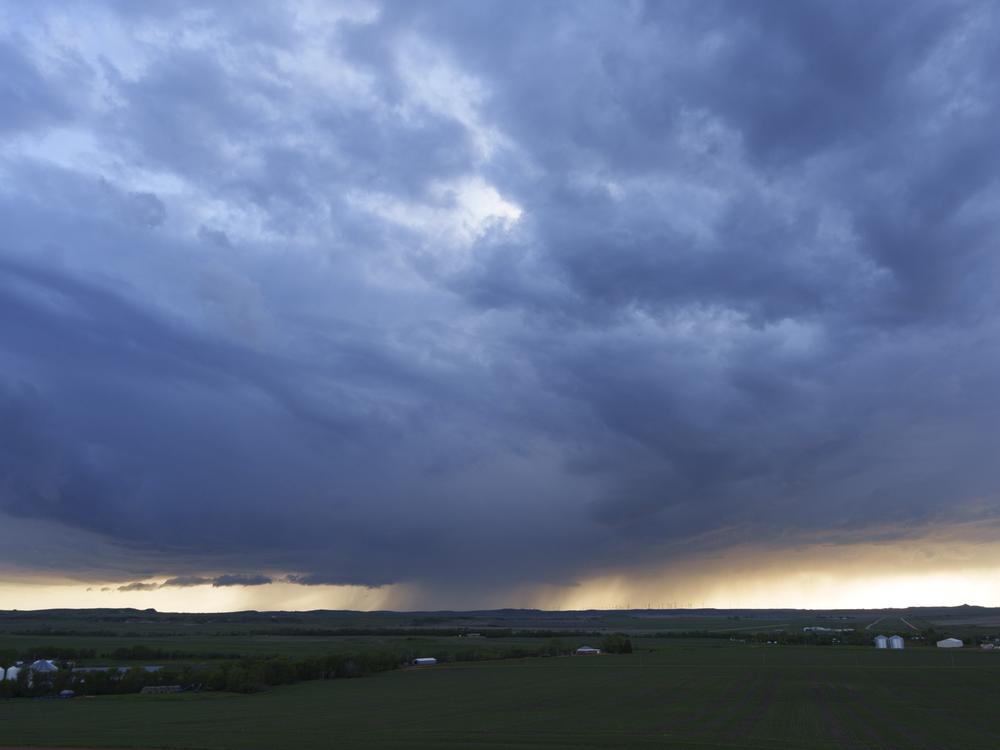 A rainstorm skirts the horizon near Glen Ullin on May 25. Inclement weather and long travel distances to medical providers are barriers to health care access for older people in Glen Ullin and many parts of the rural United States.