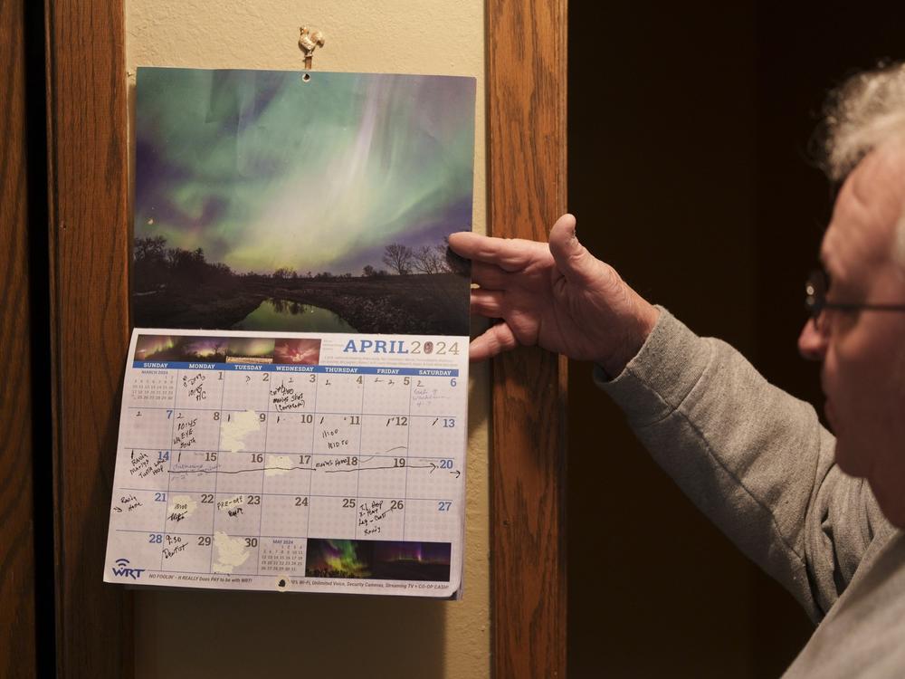 Randy Anderson flips through a calendar filled with medical appointments at his home in Turtle Lake, N.D., on May 22. Randy and his wife Marlys, who both deal with various health concerns, find their regular trips to Bismarck for care to be a considerable burden. “It’s like a full-time job almost,” Anderson said.