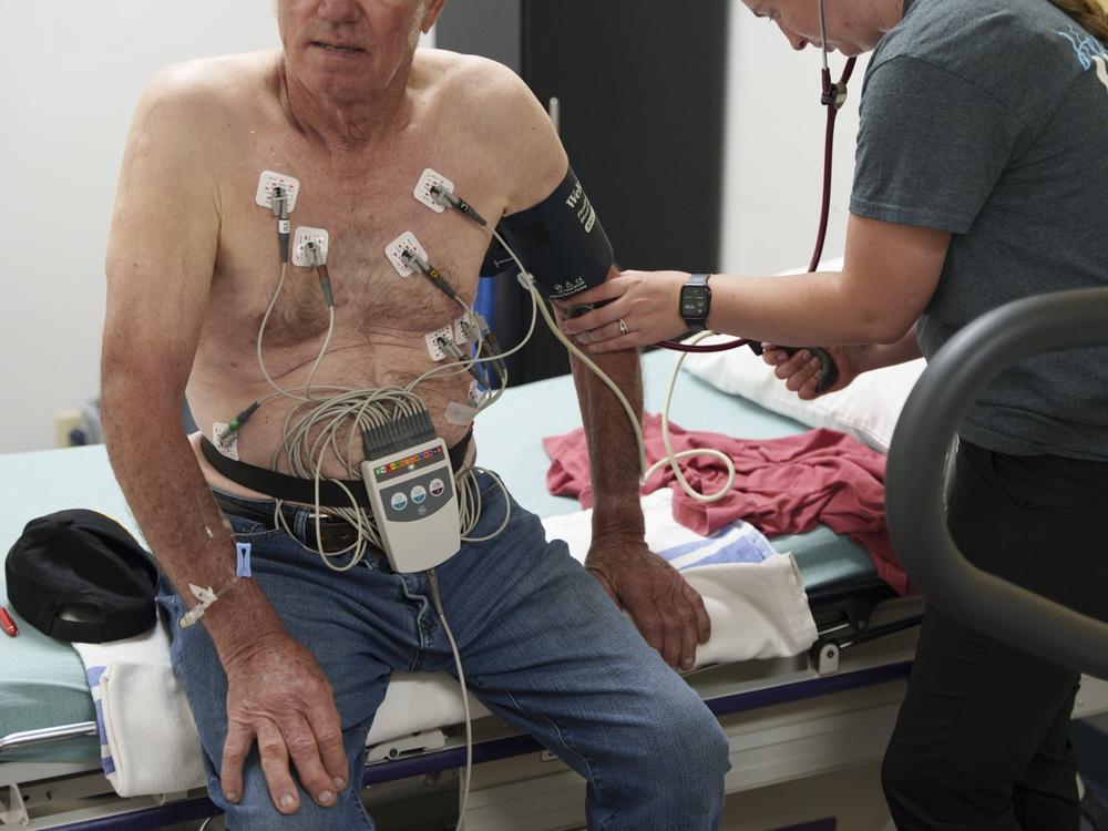 Registered nurse Ashley Vanden Hoek checks a patient’s pulse following a cardiac stress test during a special monthly visit by a cardiology team to Douglas County Memorial Hospital in Armour on May 30.