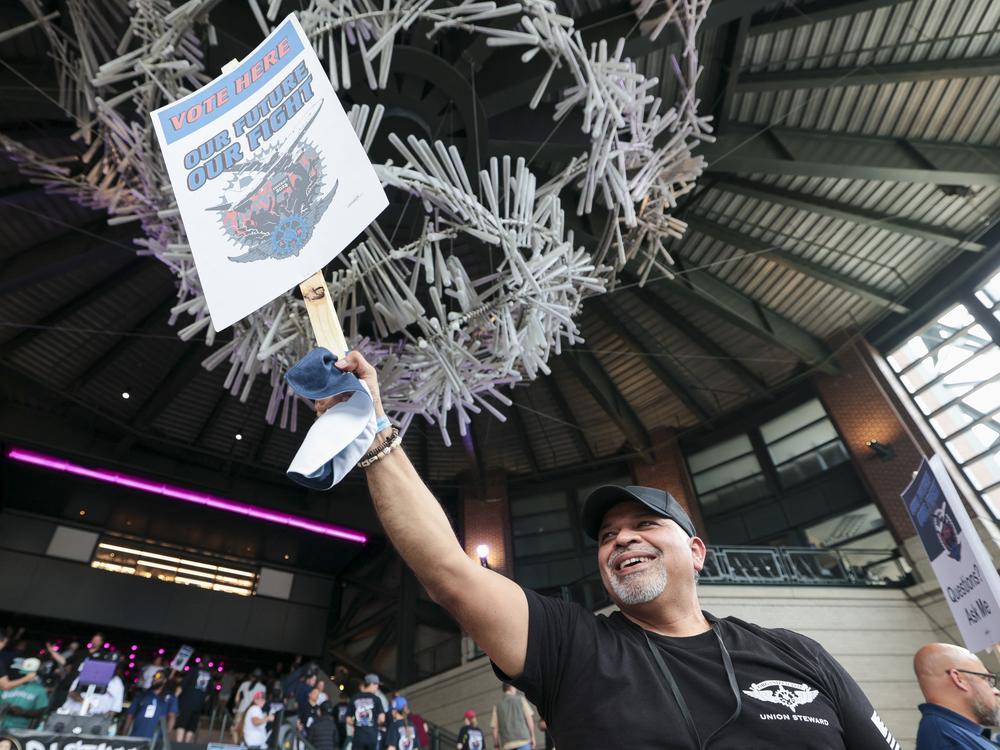 Manny Briones, an iron machinist from Seattle, welcomes members and supporters of the International Association of Machinists and Aerospace Worker Union District 751 for an early strike-sanction vote at T-Mobile Park in Seattle on July 17.