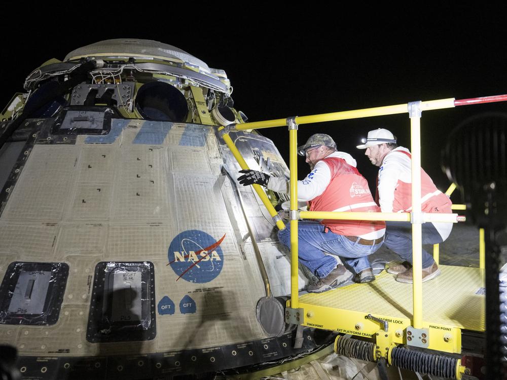 This handout image supplied by NASA shows  Boeing and NASA teams work around NASA's Boeing Crew Flight Test Starliner spacecraft after it landed uncrewed at White Sands Space Harbor, on Friday at White Sands, N.M.