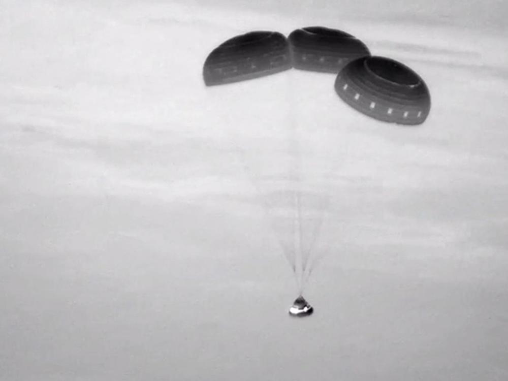 This image, taken from NASA video, shows the Boeing Starliner capsule coming down through the darkness over New Mexico. 