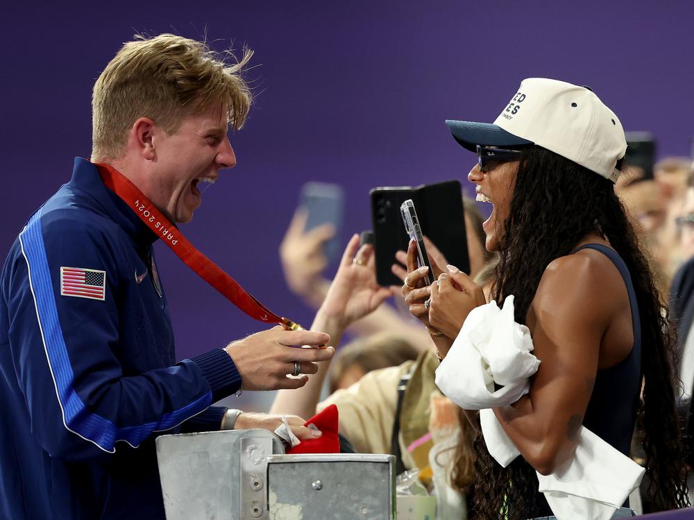 Gold medalist Hunter Woodhall of Team United States celebrates with wife and fellow Olympian Tara Davis-Woodhall during the Men's 400m T62 medal ceremony on Friday.
