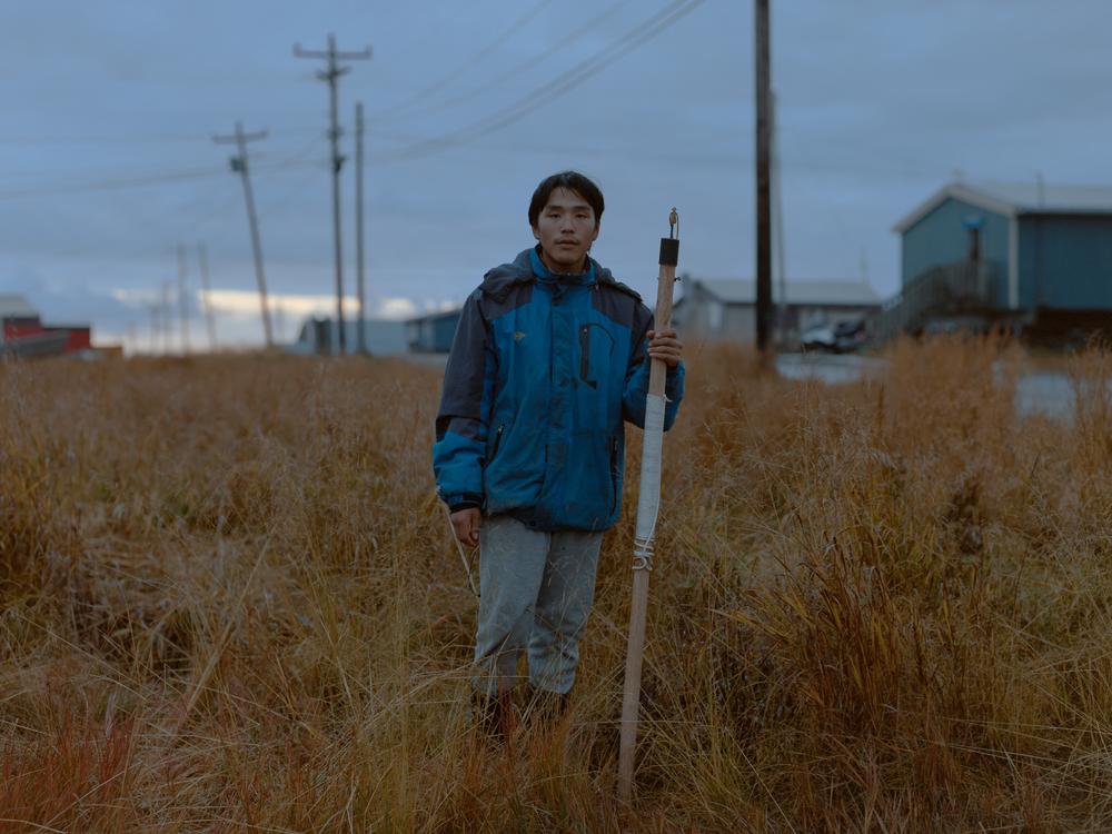 Thomas Rivers with a seal harpoon he made with his brothers. They learned traditional crafting skills through one of CANHR’s programs. Rivers has found it difficult to open up to adults about his struggles with suicidal ideation. “I’ve been depressed since I was about 10. All I'm really good at is hiding it,” he explained. After losing two uncles and several friends to suicide, Rivers found refuge in his relationships with his siblings. He credits those bonds as his reasons for being alive.<br>