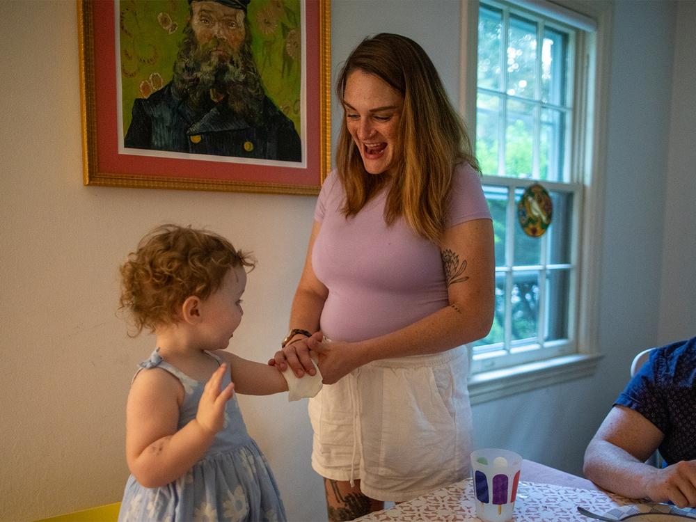  Zelda gets a temporary tattoo as a treat after dinner. Later, pictured at right, Micaeli loads dishes into the dishwasher. 