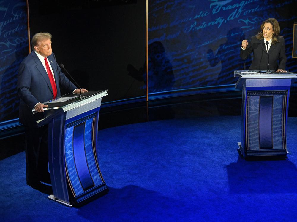 U.S. Vice President and Democratic presidential candidate Kamala Harris speaks as former U.S. President and Republican presidential candidate Donald Trump listens during a presidential debate at the National Constitution Center in Philadelphia, Pennsylvania, on Sept. 10, 2024.