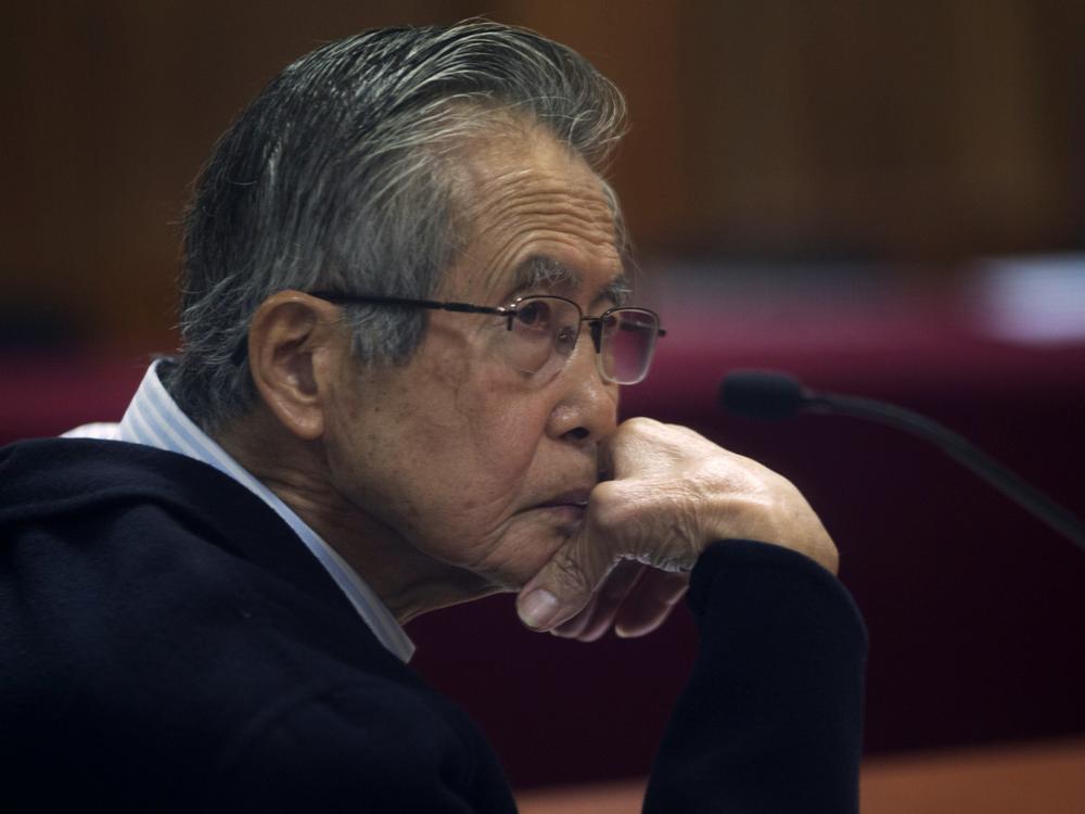 Peru's jailed former President Alberto Fujimori, photographed through a glass window, attends his trial at a police base on the outskirts of Lima, Peru, on June 28, 2016. His daughter Keiko Fujimori announced in a post on X that he died of cancer Wednesday. 