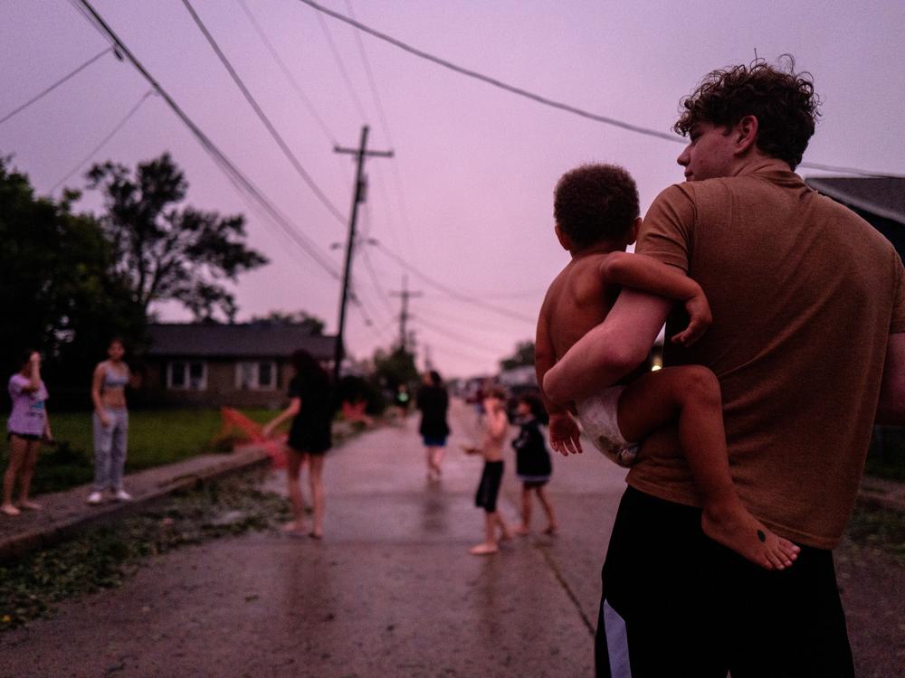 Isaiah Brown comforts his younger brother Malachi after their power went down in the Polk Street neighborhood on Sept. 11, 2024 in Houma, Louisiana.