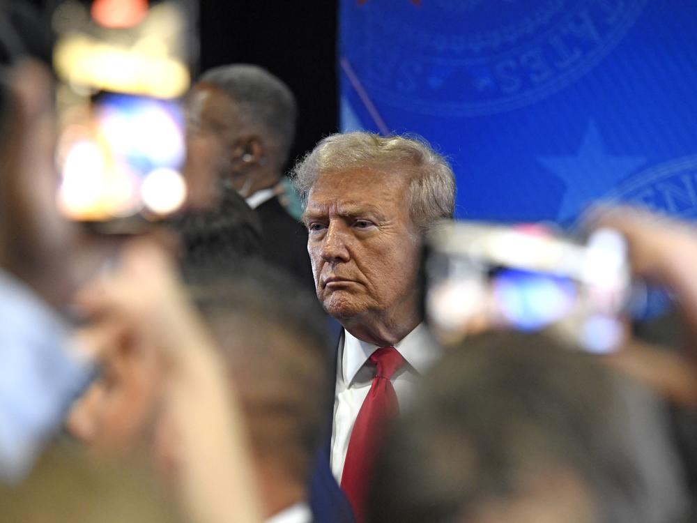 Former President Donald Trump speaks to members of the press following a presidential debate with Vice President Kamala Harris. Shares in his Trump Media company plunged to a record low the morning after the debate.